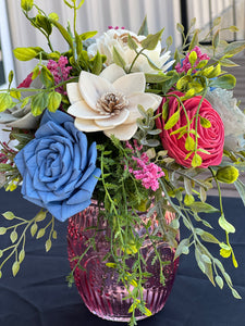 Sola wood floral arrangement in pink glass container