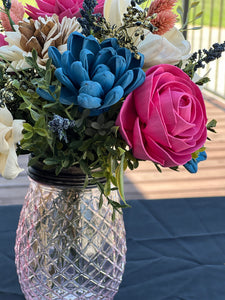 Sola wood floral arrangement in pink glass container