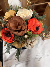 Sola wood flowers arranged in a vintage gold pitcher