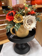 Sola wood flowers arranged in a vintage gold pitcher