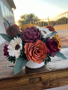 Sola Wood flowers arranged in a small ceramic dish