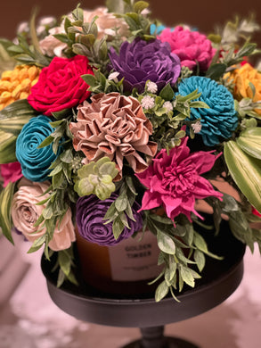 Sola Wood Flower arrangement arranged on lid of candle