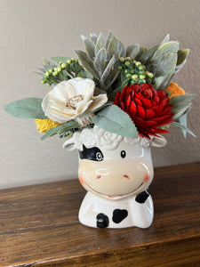 Sola Wood floral arrangement in Cow planter