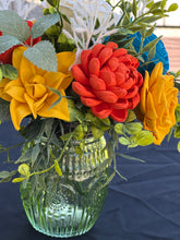 Sola wood floral arrangement in green glass container