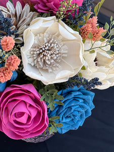 Sola wood floral arrangement in pink glass container