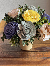 Sola Wood floral arrangement in terra cotta pot