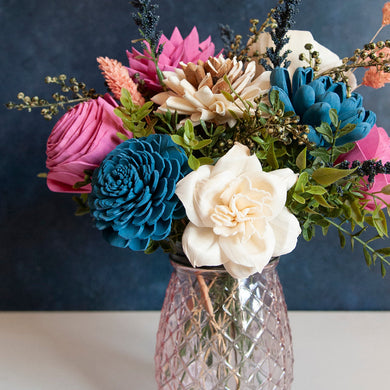 Sola wood floral arrangement in pink glass container