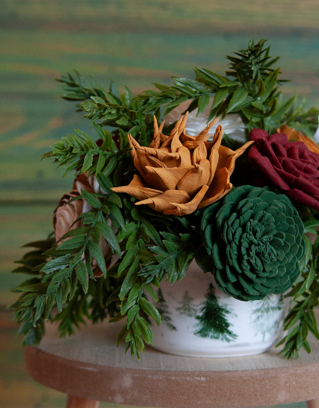 Sola Wood flower arrangement in container with trees on it.