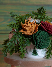 Sola Wood flower arrangement in container with trees on it.