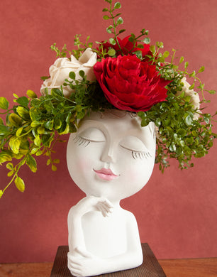 Fun sola wood floral arrangement in a elegant women face planter