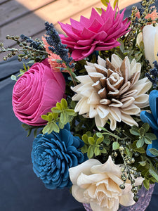 Sola wood floral arrangement in pink glass container