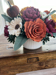 Sola Wood flowers arranged in a small ceramic dish