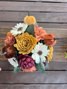 Sola Wood flowers arranged in a small ceramic dish