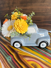 Grey truck with Sola Wood flowers
