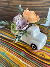 White truck with Sola Wood flowers